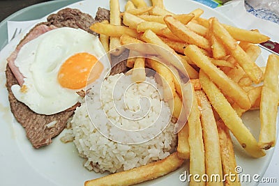 Traditional Portuguese food Prego no Prato with rice, chips, egg and beef. Stock Photo