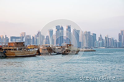 Traditional Qatari dhow boats with the skyline of Doha West Bay skyscrapers Editorial Stock Photo