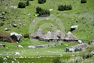 Traditional quechua village houses with conic straw roof Stock Photo