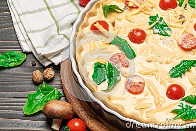 Traditional quiche tart in baking form with filling Stock Photo