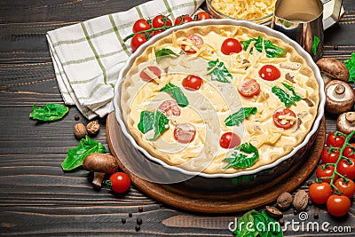 Traditional quiche tart in baking form with filling Stock Photo