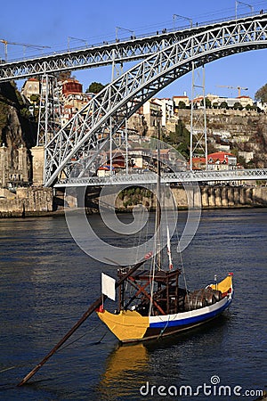 Traditional rabelo boats, Porto city skyline, Douro river and and Dom Luis or Luiz iron bridge. Porto Stock Photo