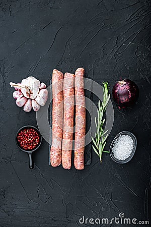 Traditional raw sausages, flat lay, on black background Stock Photo