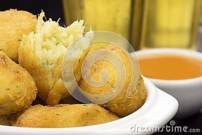 Traditional recipe codfish balls in a pub table with one open in close Stock Photo