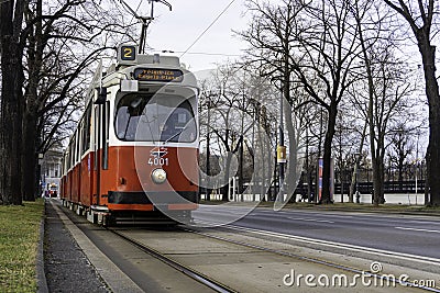 Traditional red electric tram in the streets of Vienna on a late winter afternoon Editorial Stock Photo