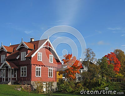 Traditional red scandinavian house in autumn Stock Photo
