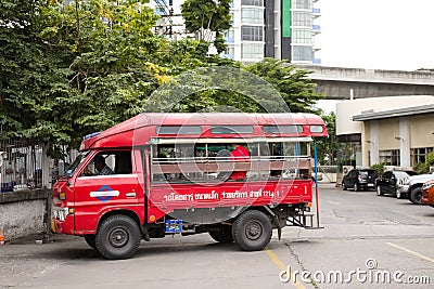 Red truck bus for passenger in village or local small street or slley Editorial Stock Photo