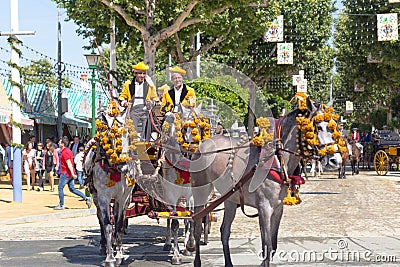 Traditional riding horse carriages celebrating Seville`s April Fair. Editorial Stock Photo