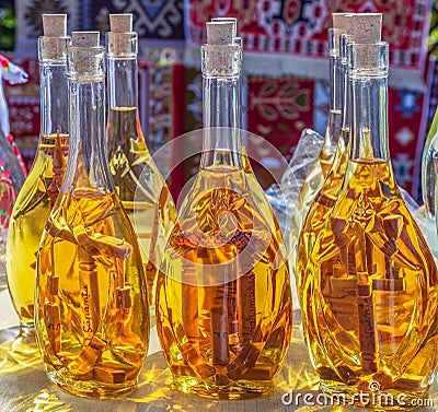 Traditional Romanian drink in bottles decorated with wooden interior crosses. Sapanta, Maramures, Romania Editorial Stock Photo