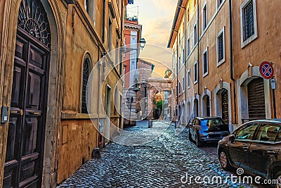 Traditional Rome street in the centre, stone pavement and ancient gates, no people Stock Photo