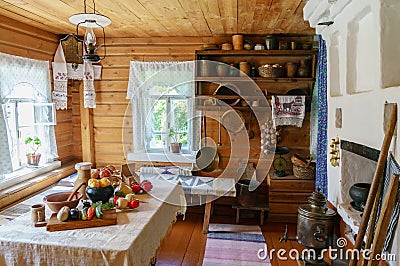 Traditional Russian cottage with oven and crockery. Interior of a peasant hut Stock Photo