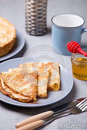 Traditional Russian pancakes with honey. Shrovetide. Stock Photo