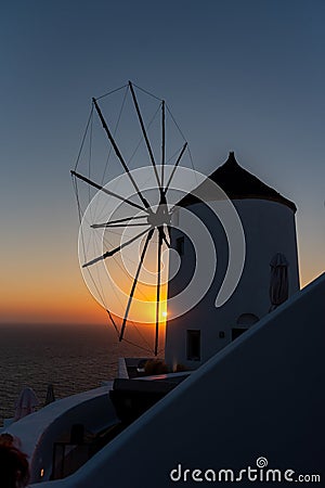 Traditional Santorini windmill at sunset. Stock Photo