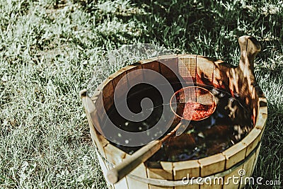 Traditional Sauna with Water Bucket and Ladle on backgorund of grass and birch tree Stock Photo