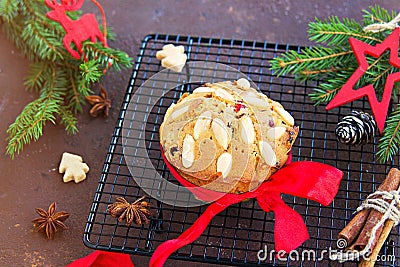 A traditional Scottish Christmas fruit mini Dundee cake with a mix of dried fruits, decorated with peeled almonds, on a black wire Stock Photo