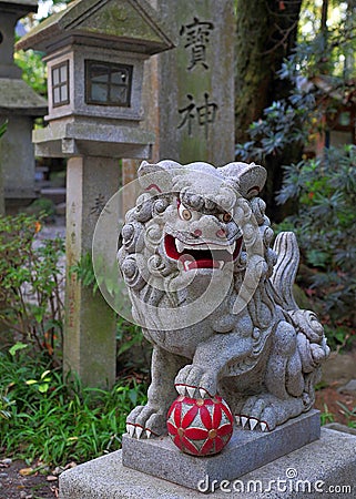 Traditional sculpture of a lion at the gate of a japanese temple Stock Photo