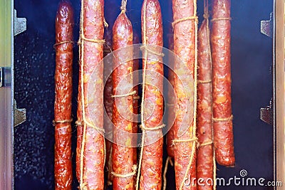 A traditional smokehouse where sausages are smoked meat is hung to dry. Stock Photo