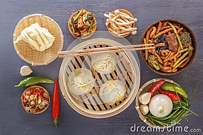 Traditional snacks of Chinese cuisine dim sum - dumplings, spicy salads, vegetables, noodles, steam bread Stock Photo
