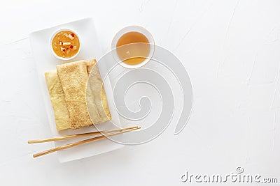 Traditional snacks of Chinese cuisine Dim Sum - tortillas - bings in a plate on a white background. View from above. Stock Photo