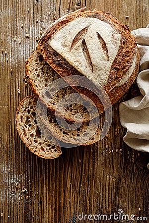 Traditional sourdough loaf of bread baked in a craft bakery on a wooden background Stock Photo