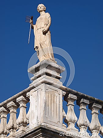 Traditional statue as a decoration on the roof of a classic house in Leiria Stock Photo
