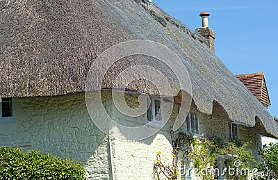 Traditional stone cottage with reed thatched roof Stock Photo