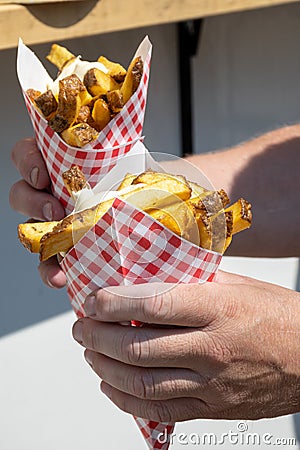 Traditional street food in Belgium and Netherlands, French fried potatoes chips with mayonnaise sauce in paper cone bag Stock Photo