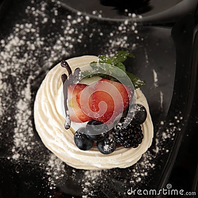 Traditional summer dessert pavlova with fresh berries Stock Photo