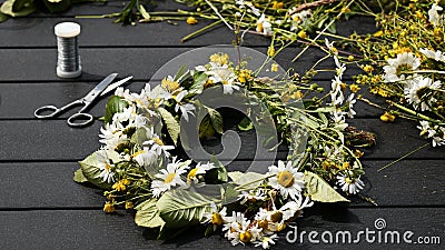 Creating flower crown for Midsummer Eve in Sweden Stock Photo