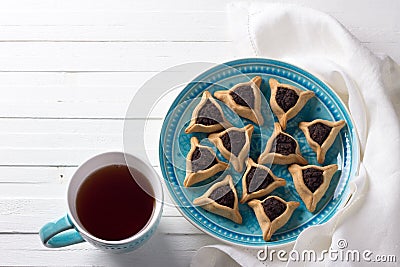 Hamantashen cookies or ears of Haman, triangular cookies with Hamantashen cookies or Aman ears, triangular cookies with poppy seed Stock Photo