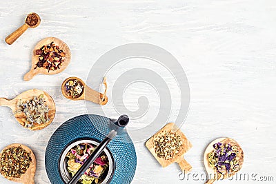 Traditional tea ceremony setup, teapot and variety of tisanes with herbs and dry fruits tea. Tisane detox, relaxation, healing, Stock Photo