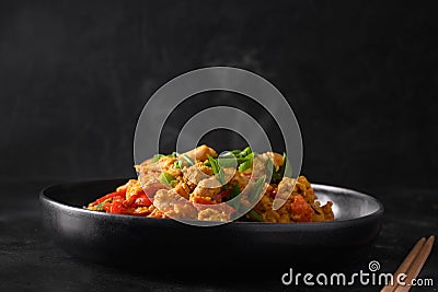 Traditional Thai breakfast gai pad pongali with chicken, eggs, spicy, yellow thai curry paste on rice. Stock Photo