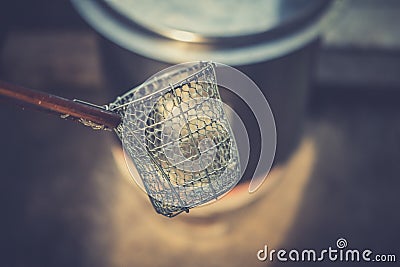 Traditional Thai steel wire mesh noodle strainer Stock Photo