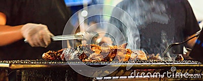 Traditional Thai Street Food, Beef barbecue grill on outdoor fireplace for roasting meat, cooked over open flame or live coal, Stock Photo