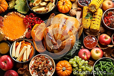 Traditional Thanksgiving day feast with delicious cooked turkey and other seasonal dishes as background, top view Stock Photo