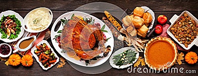 Traditional Thanksgiving turkey dinner. Top view table scene on a dark wood banner background. Stock Photo