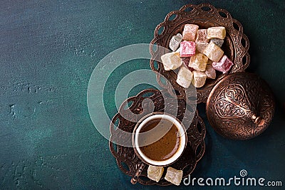 Traditional turkish coffee and turkish delight on dark green wooden background. flat lay Stock Photo