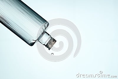 Traditional Turkish cologne dripping from a bottle on white background Stock Photo