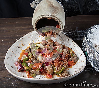 Traditional turkish cuisine. Testi kebab, local food in Turkey. Authentic Turkish Testi Kebab cooked in earthenware water jug Stock Photo