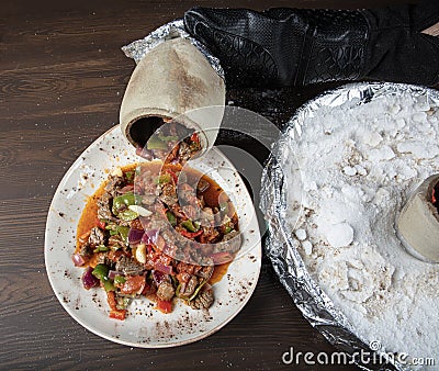 Traditional turkish cuisine. Testi kebab, local food in Turkey. Authentic Turkish Testi Kebab cooked in earthenware water jug Stock Photo