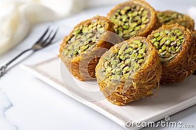 Traditional Turkish desserts; Kadaif stuffed with pistachios. Turkish name; Kadayif dolmasi or dolma kadayif Stock Photo