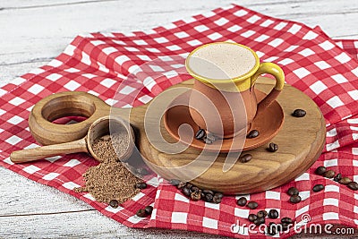 Traditional Turkish Dibek coffee in coffee cup on wooden table. Turkish dibek coffee grinded in a large stone mortar with the Stock Photo