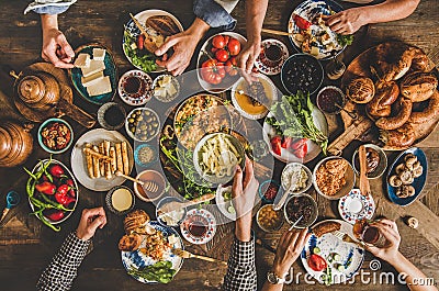 Traditional Turkish family breakfast table and people taking various food Stock Photo