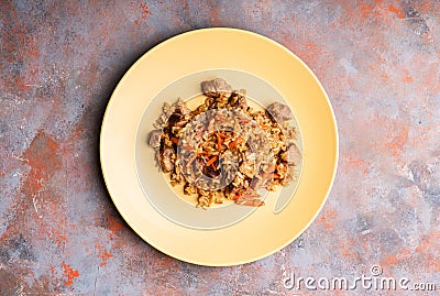 Traditional Uzbekistan pilaf on the rustic background Stock Photo