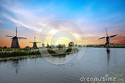 Traditional windmills at Kinderdijk in the Netherlands at sunset Stock Photo