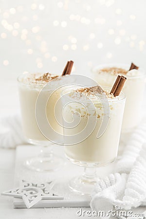 traditional winter eggnog cocktail with whipped cream and cinnamon for Christmas Stock Photo