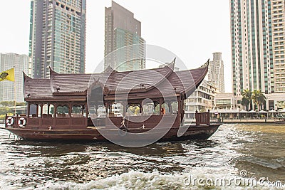 Traditional wooden boat with restaurant on the Chao Phraya river cruising tour. River view of the tourist boat takes visitors for Stock Photo