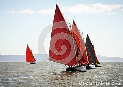 Traditional wooden boats with red sail. Stock Photo
