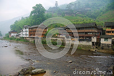 Traditional wooden buildings at the bank of the river in Longsheng near Guilin in Guanxi, China. Editorial Stock Photo