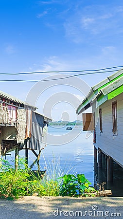 Traditional wooden house and Modern house roadside of fisherman village. Stock Photo